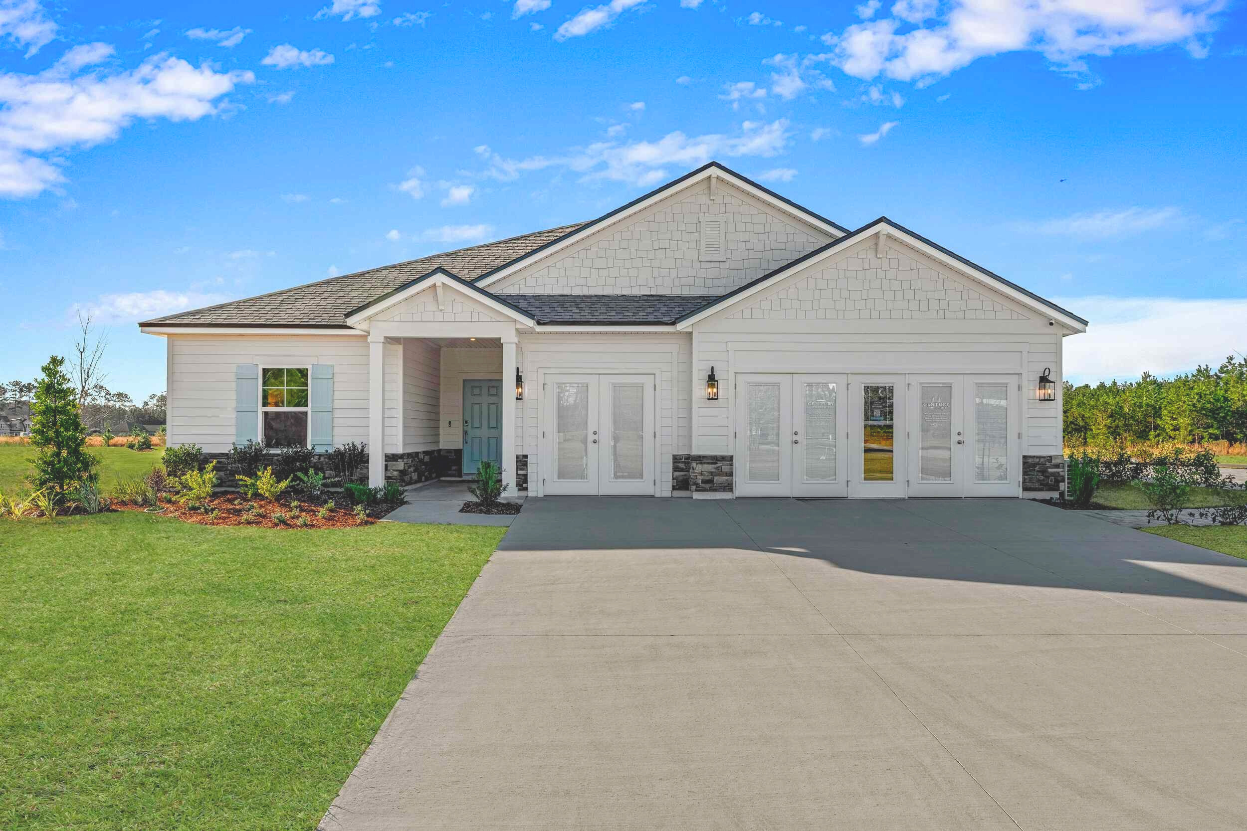 A white house with a driveway.