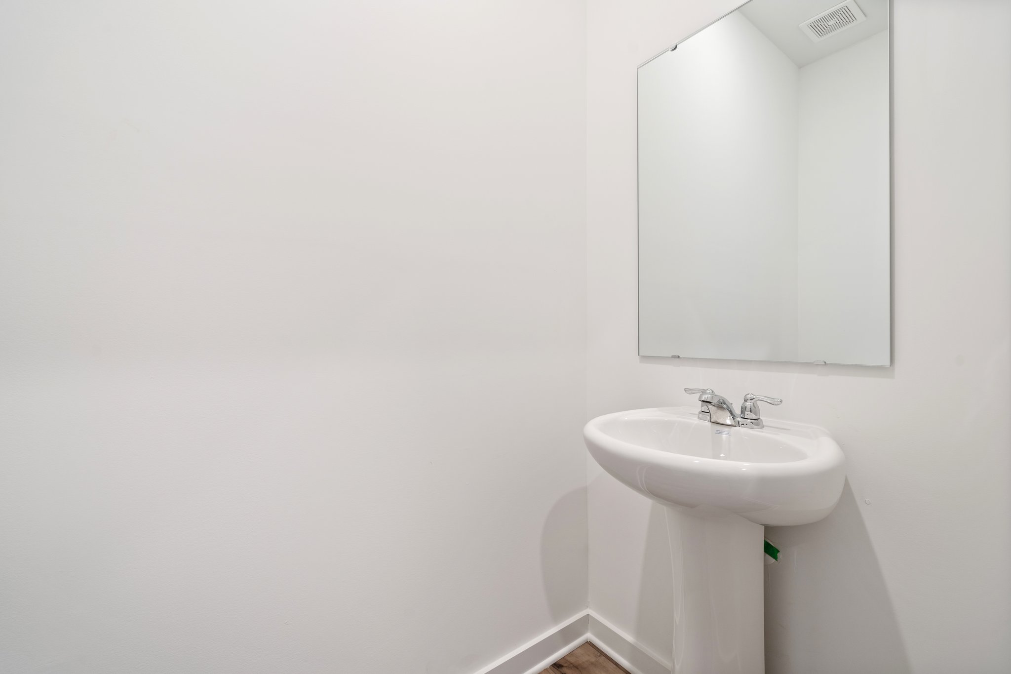 A bathroom with a mirror and sink.