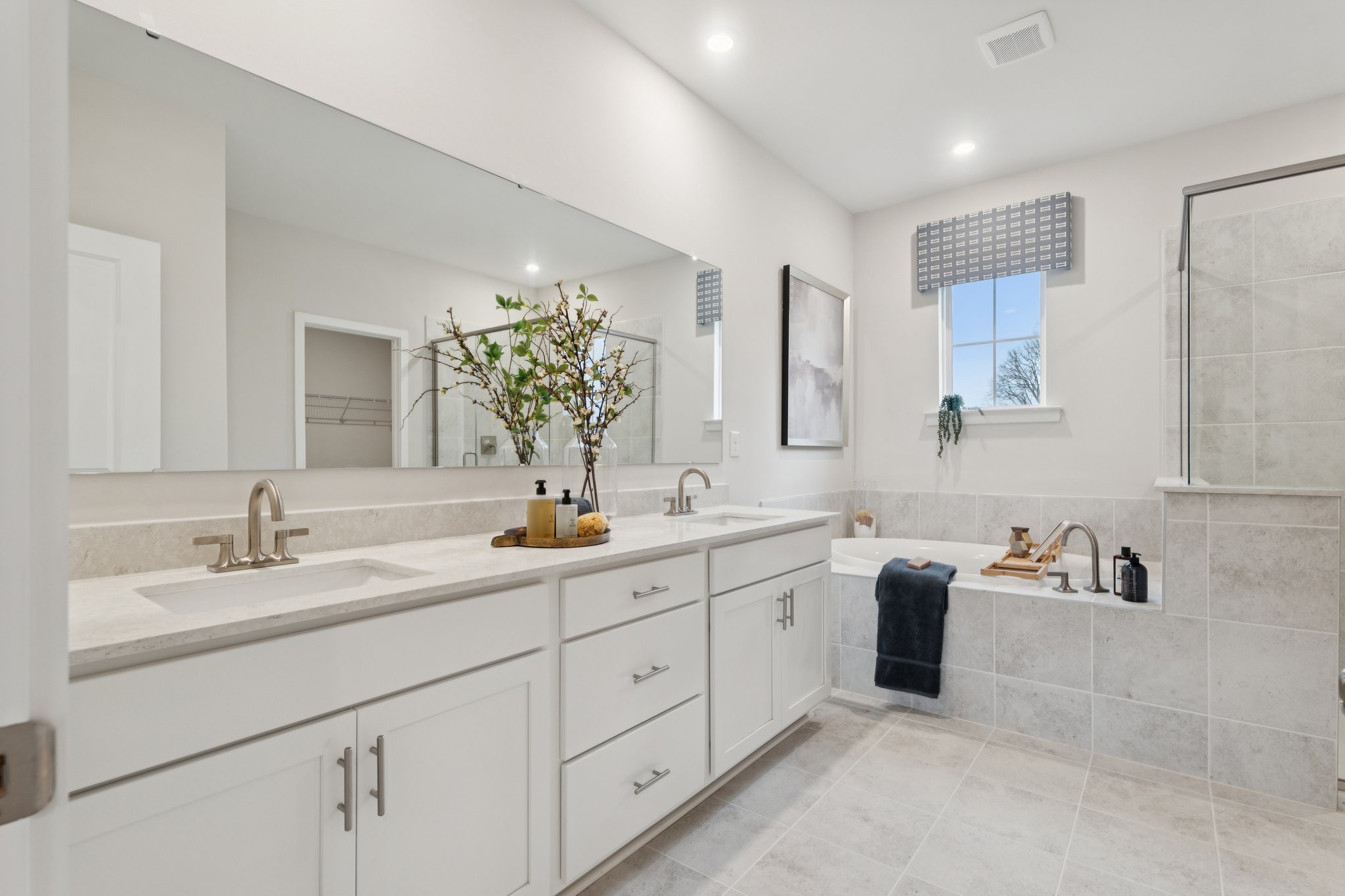 A bathroom with a large mirror.