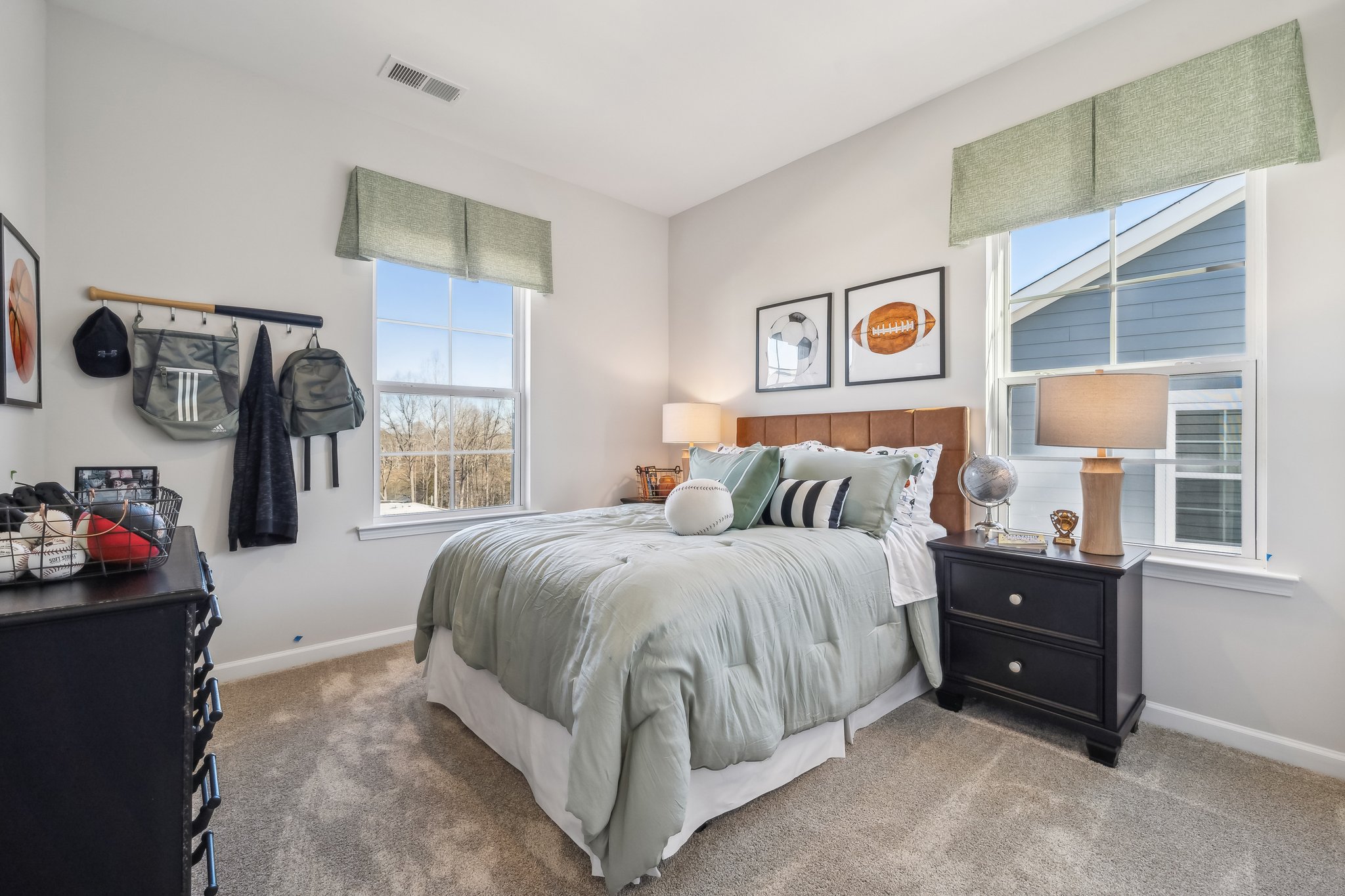 A bedroom with a bed and a dresser.