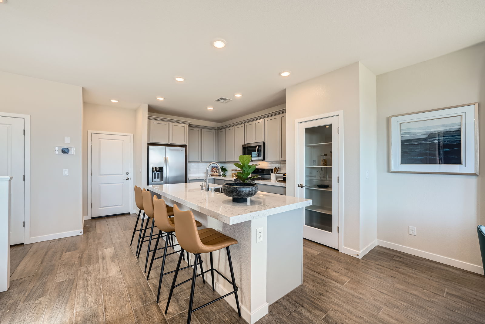 A kitchen with a table and chairs.