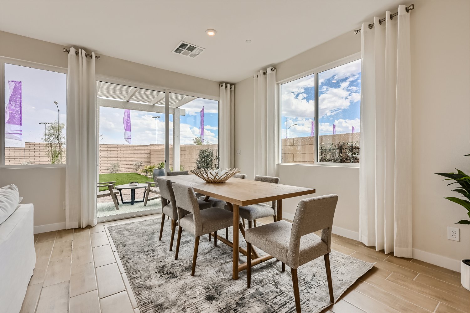 A dining room with a large window.
