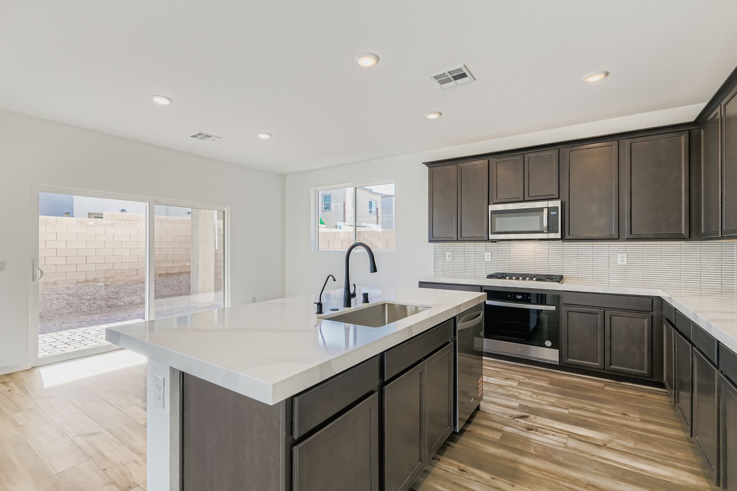 A kitchen with black cabinets.