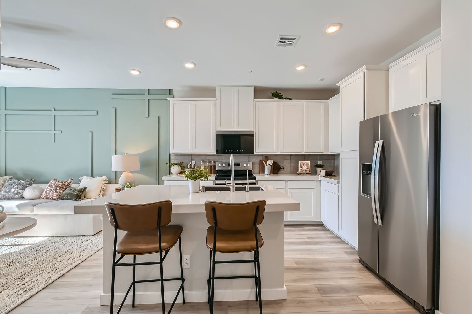 A kitchen with white cabinets.