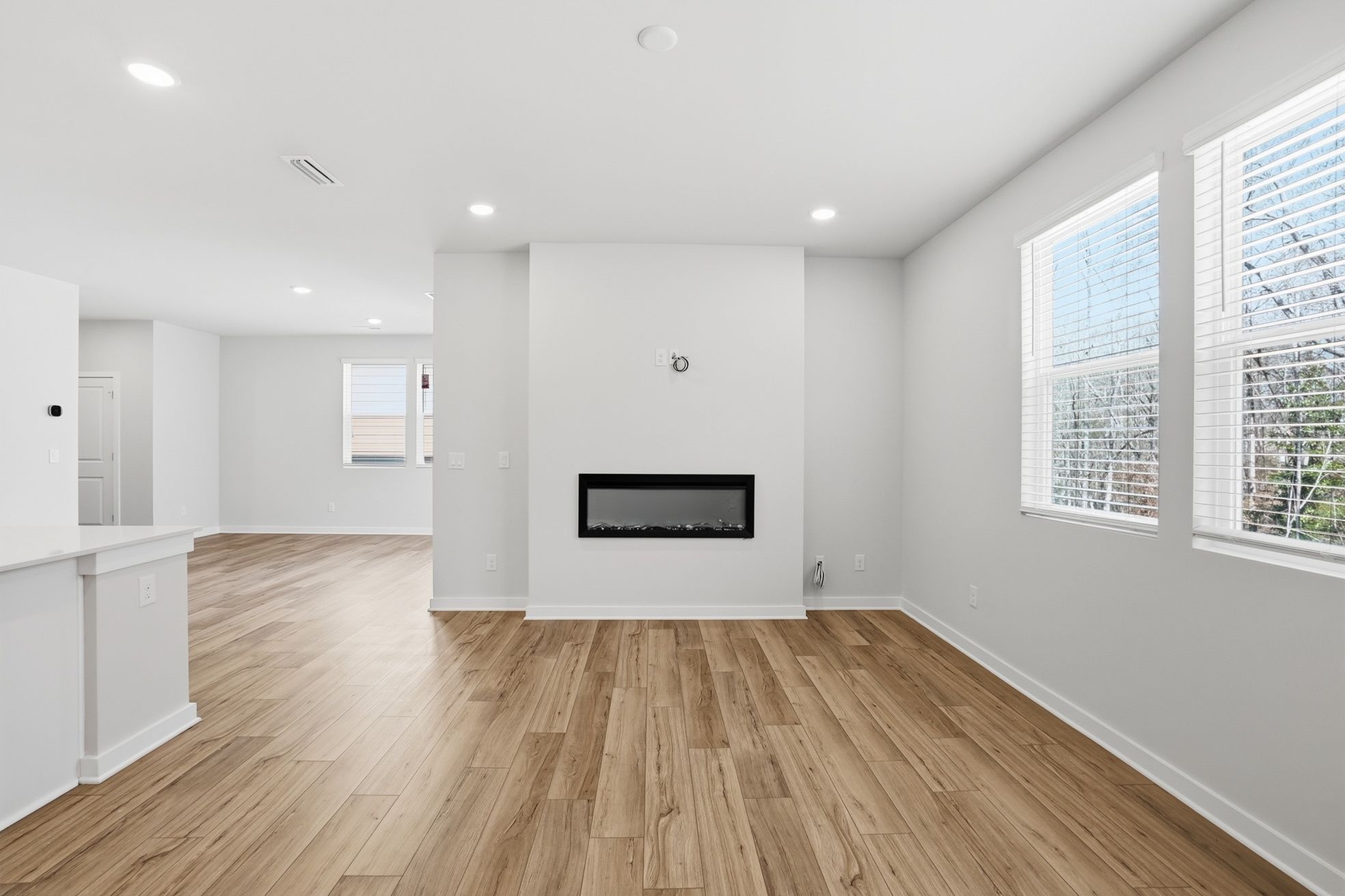 A room with white walls and wood floors.