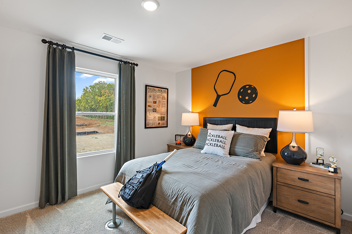 A bedroom with a large window.