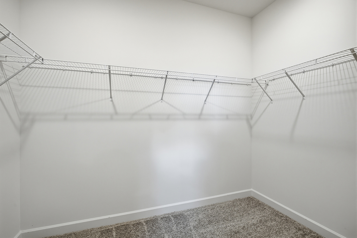 A white wall with a metal railing.