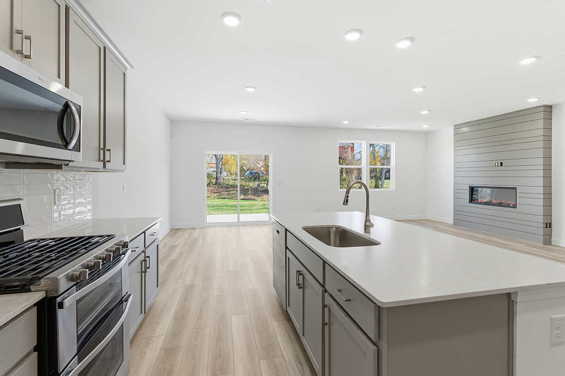 A kitchen with white cabinets.