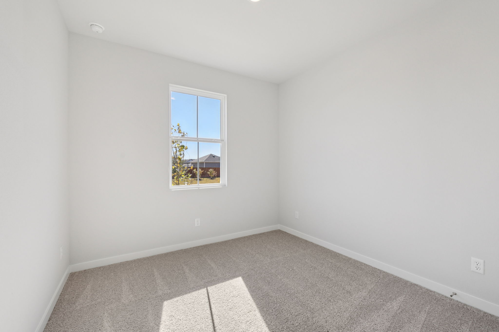 A room with a window and a tile floor.