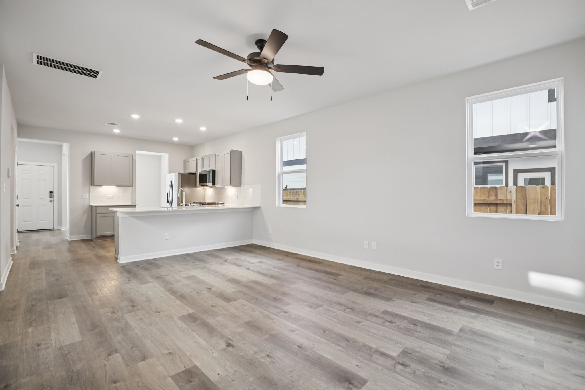 A kitchen with a wood floor.