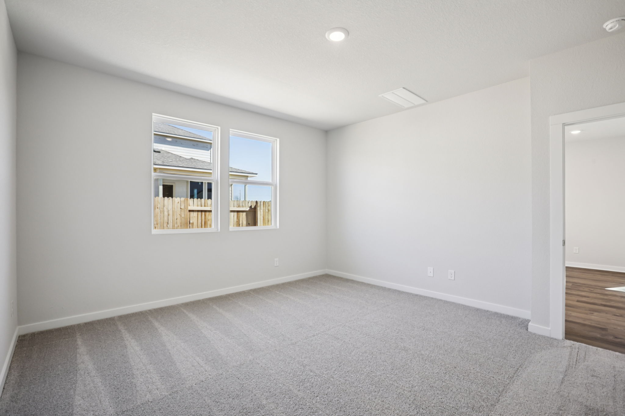 A room with a window and a door.