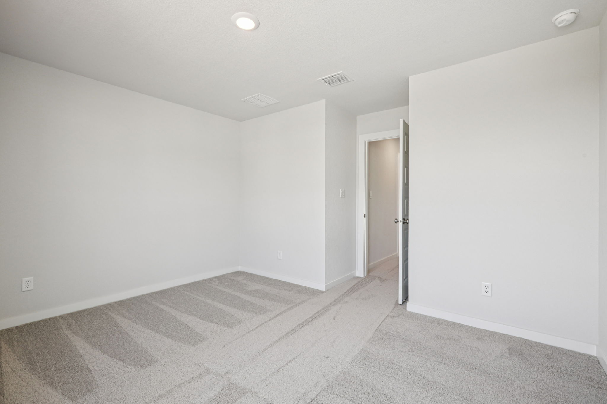 A hallway with white walls.