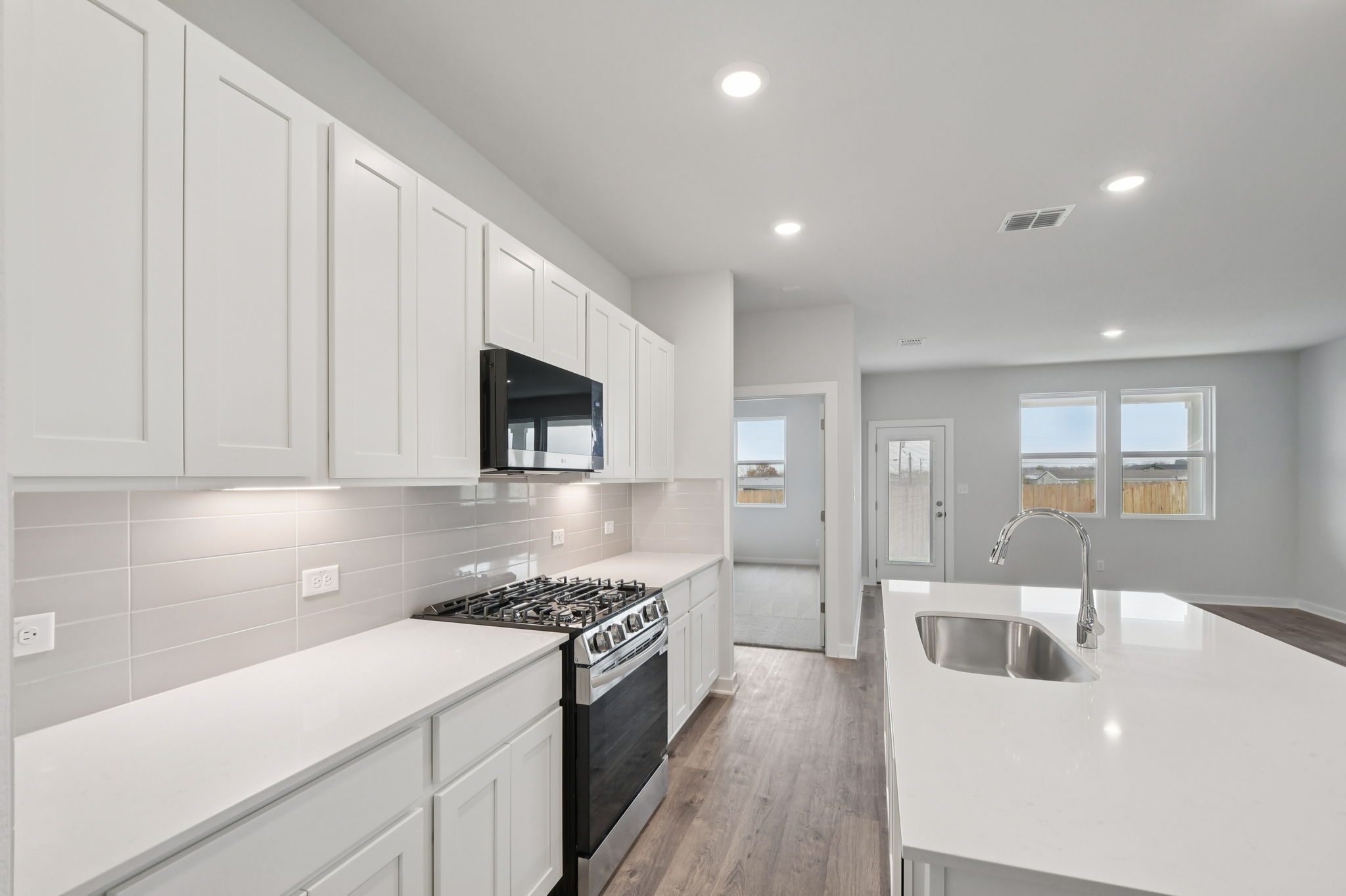 A kitchen with white cabinets.