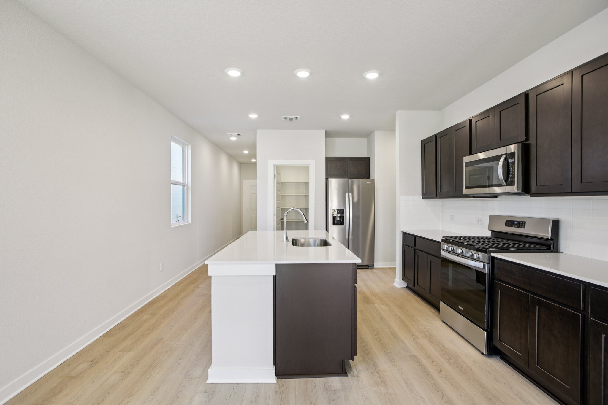 A kitchen with black cabinets.