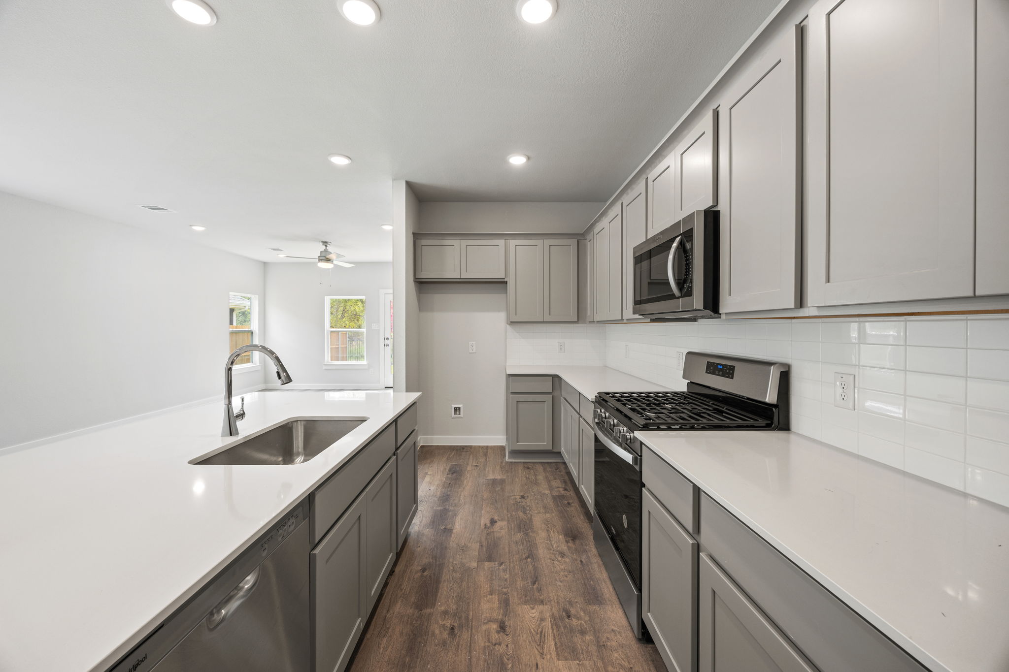 A kitchen with white cabinets.