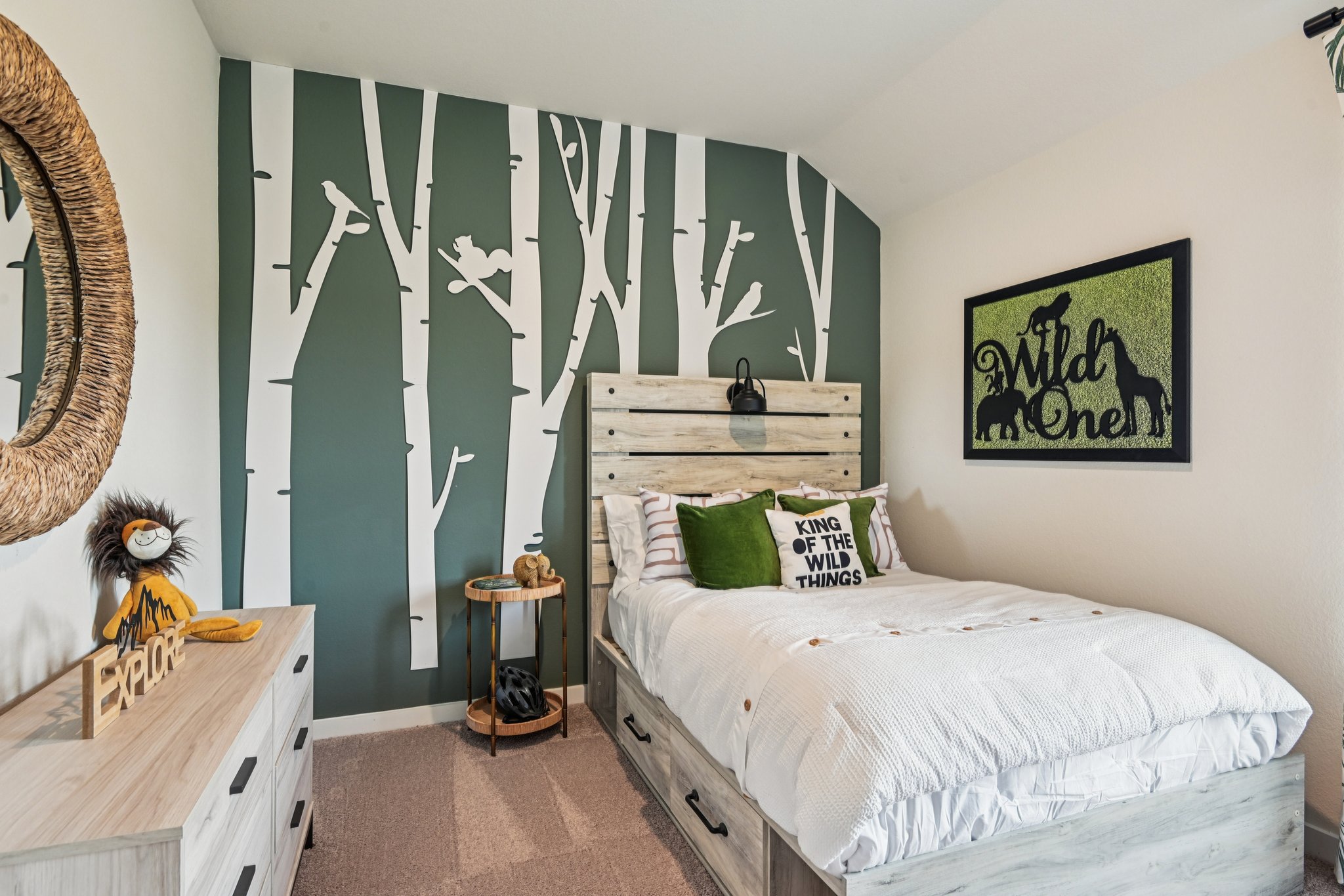 A bedroom with a bed and a mirror.