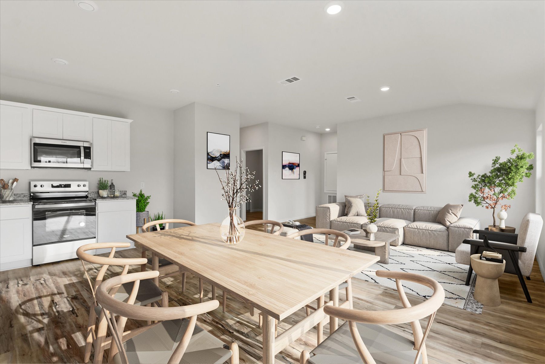 A large kitchen with a dining table.