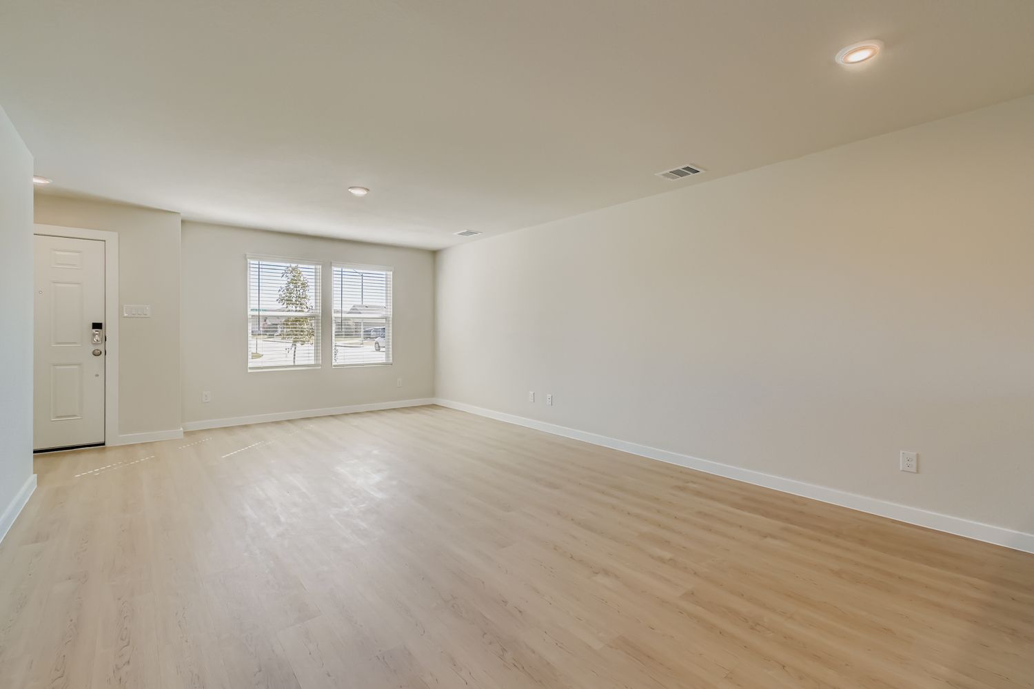 A room with a wood floor and white walls.