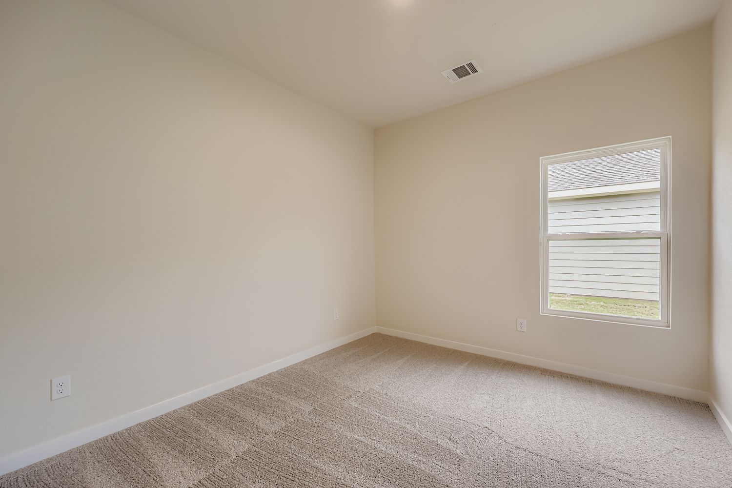 A room with a window and carpet.