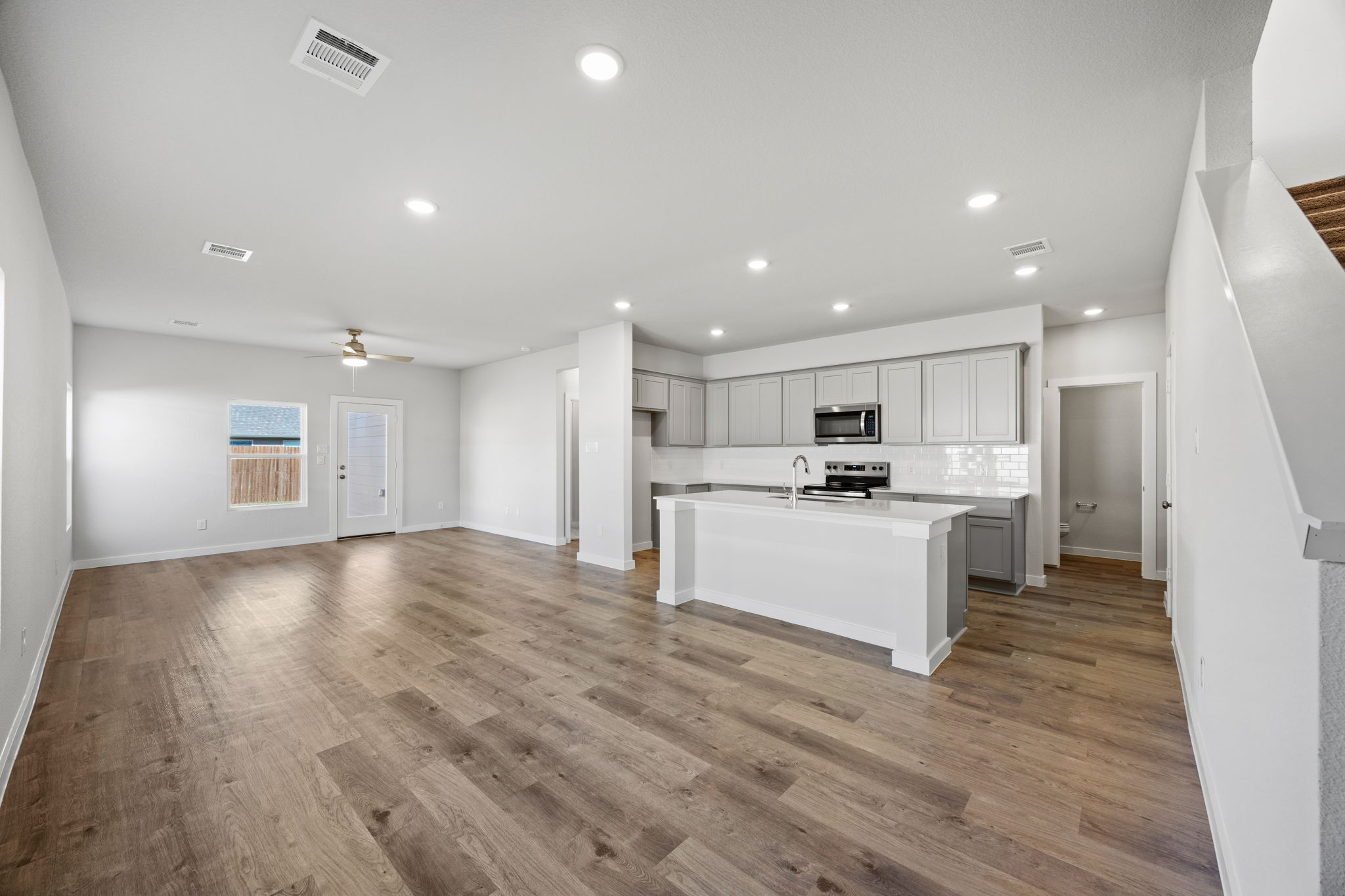 A large kitchen with white cabinets.