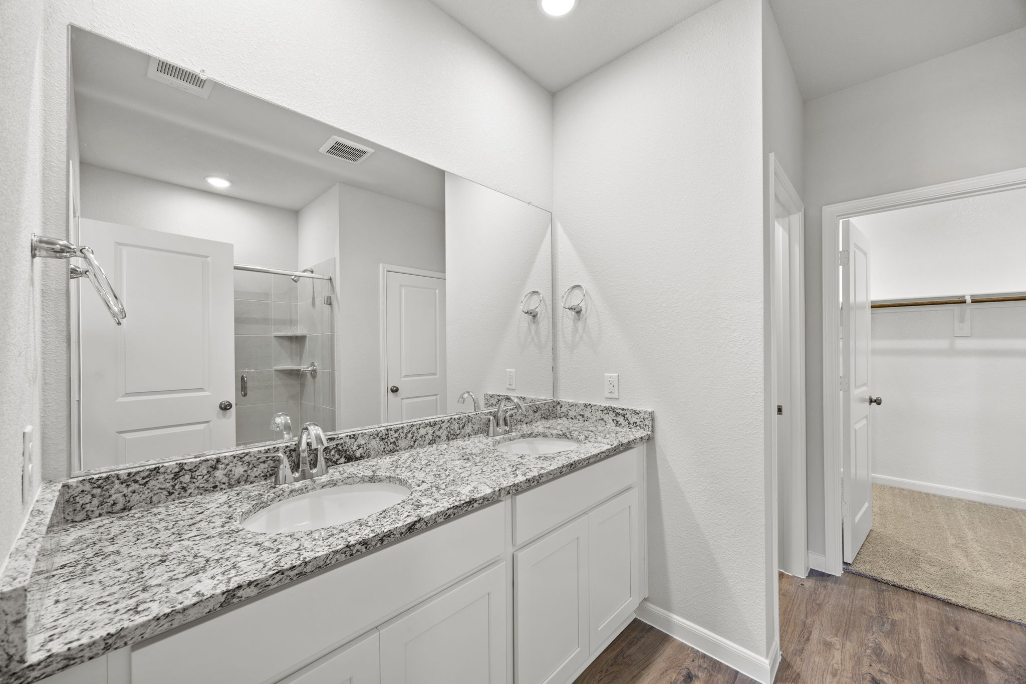 A bathroom with a large mirror.
