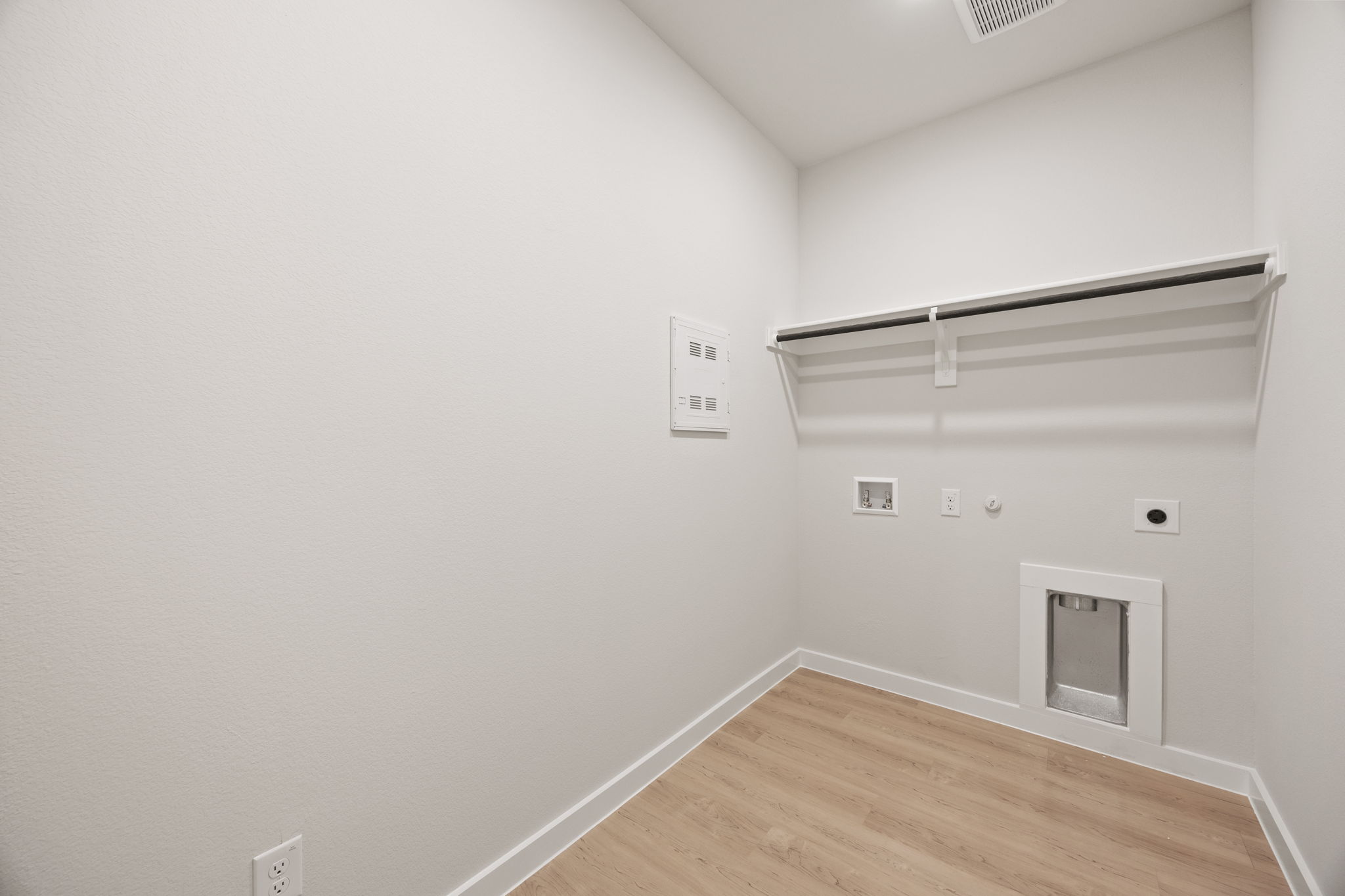 A white room with a wood floor.