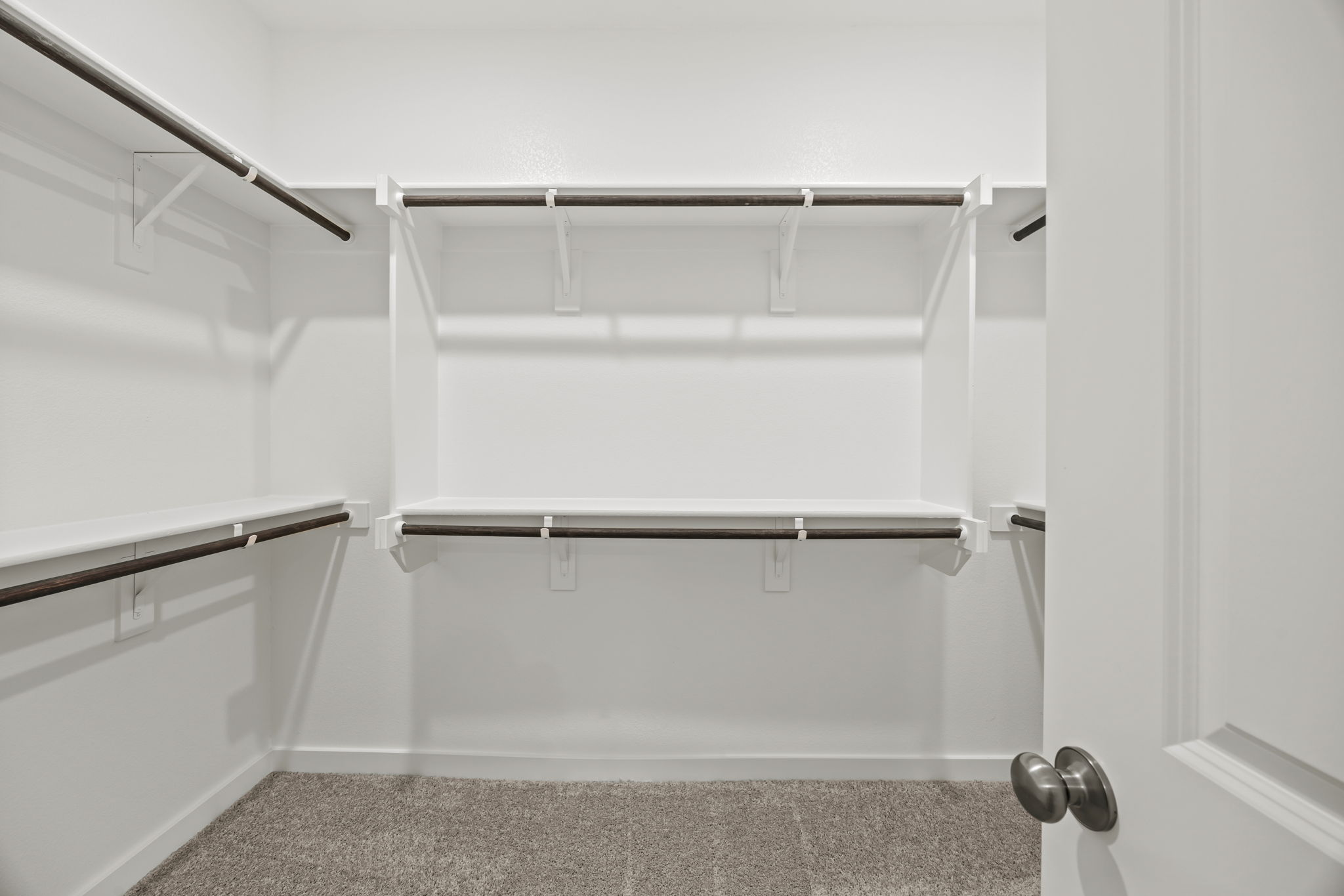 A shower with a metal bar.