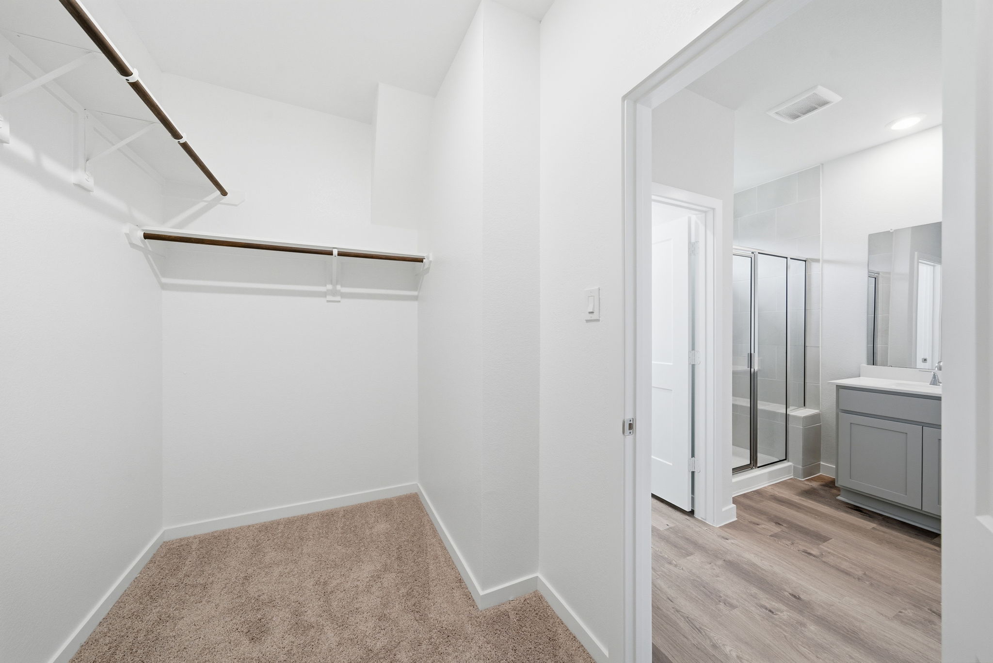 A bathroom with a glass door.
