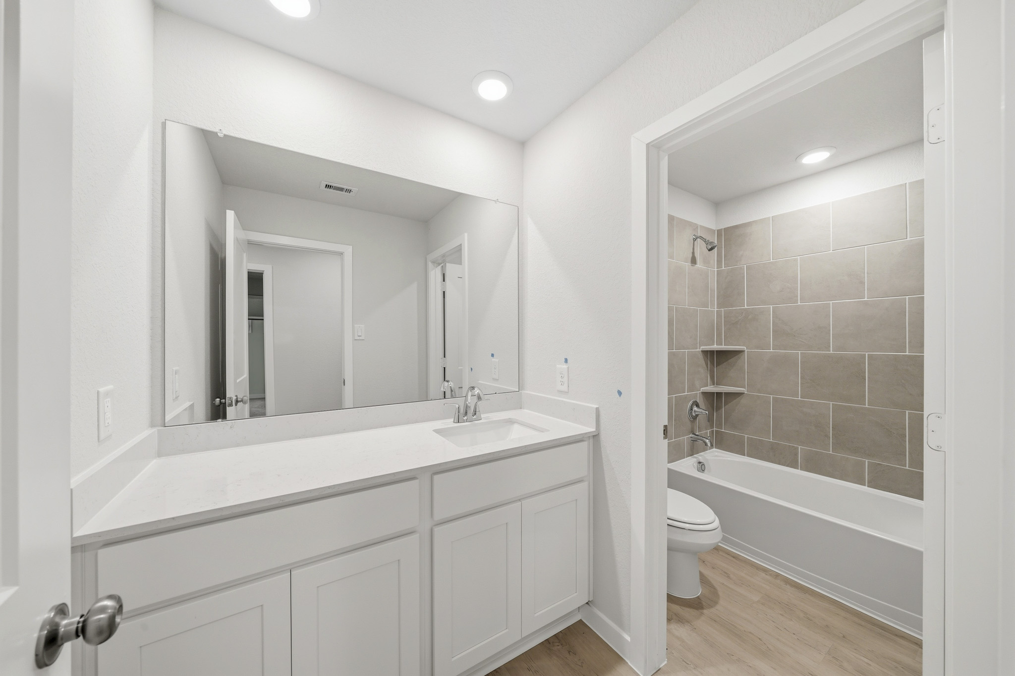 A bathroom with a tub sink and toilet.