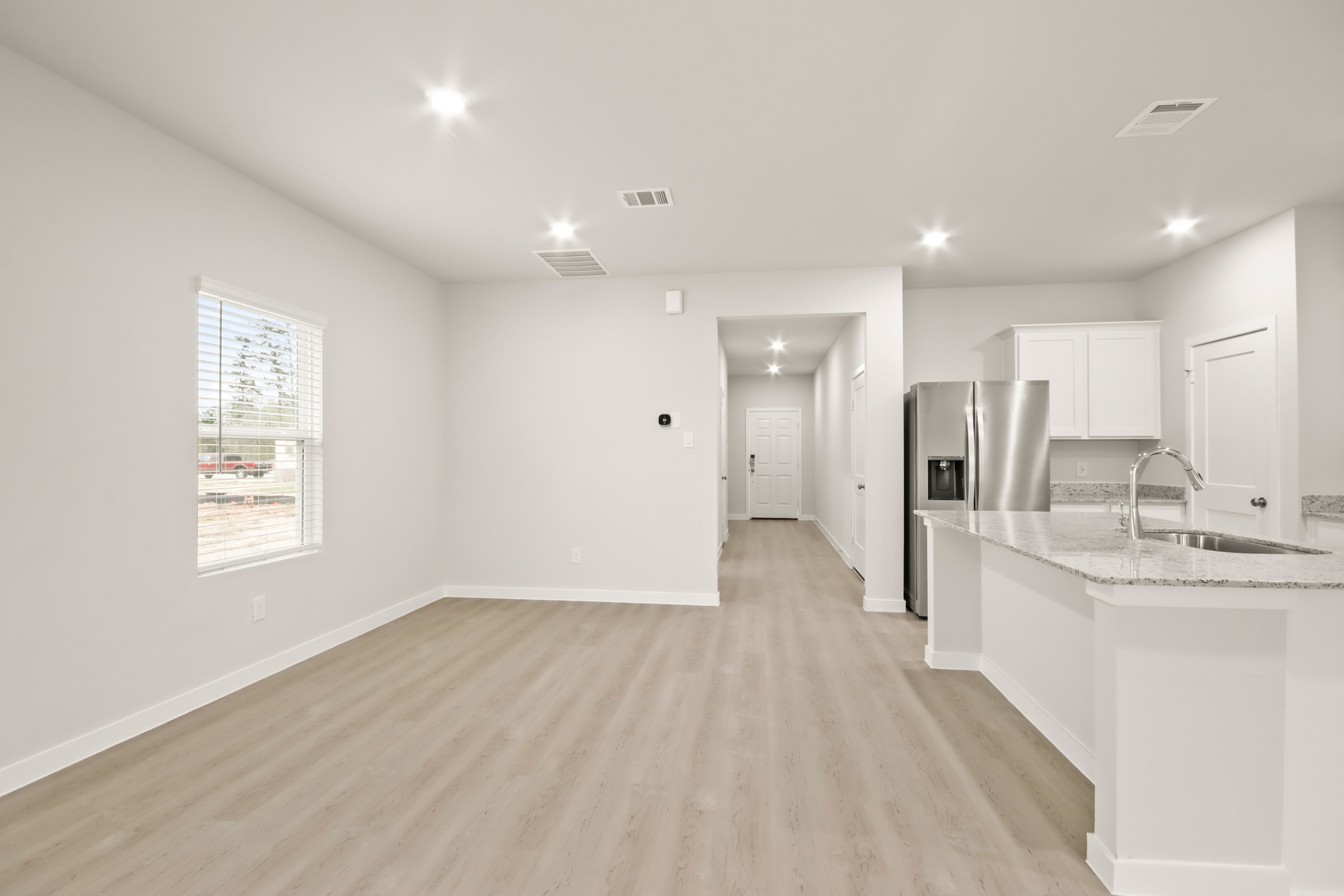 A kitchen with white cabinets.