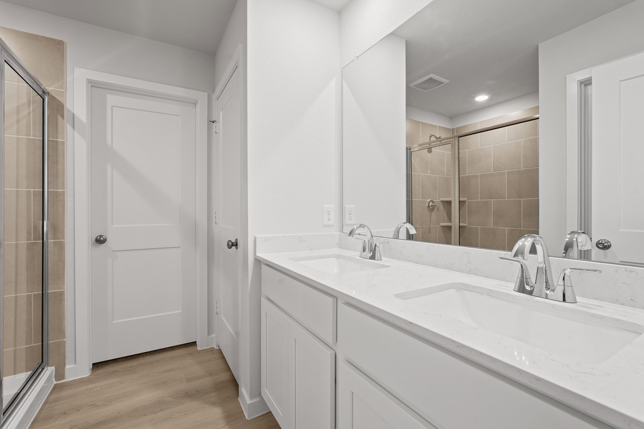 A bathroom with a large mirror.