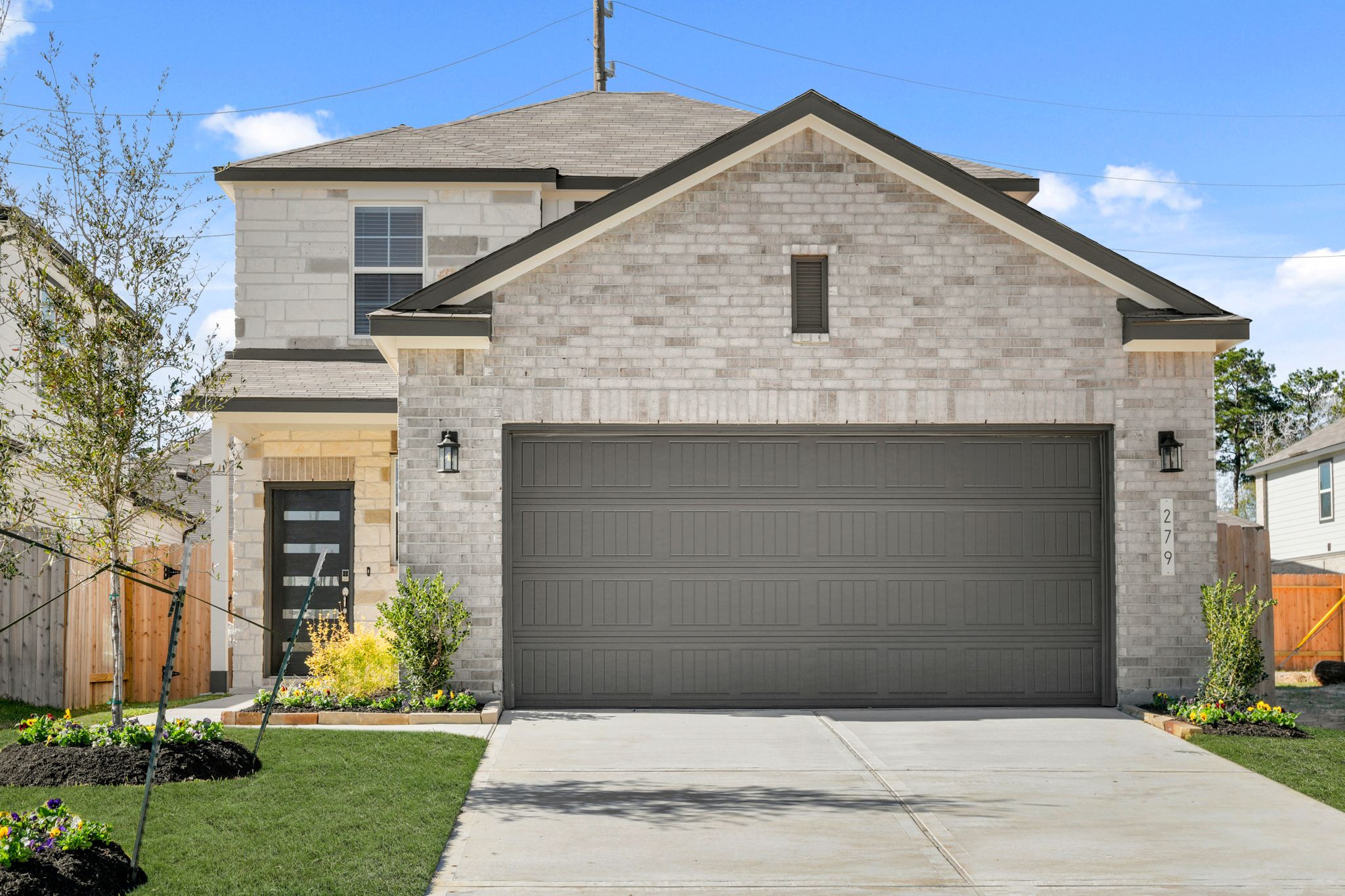 A grey house with a garage.