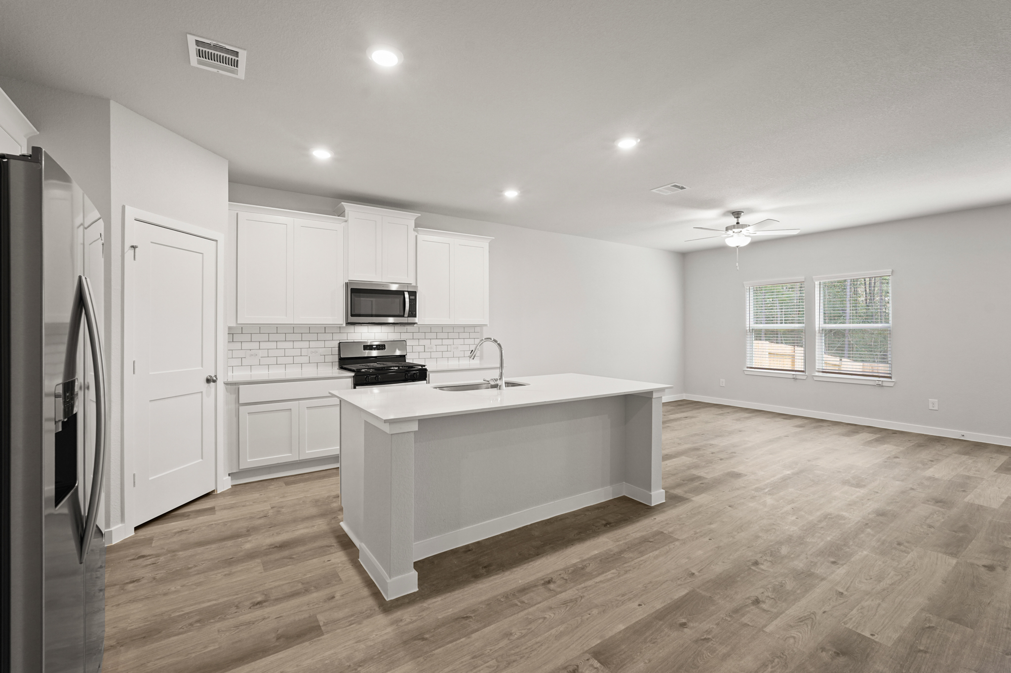 A kitchen with white cabinets.
