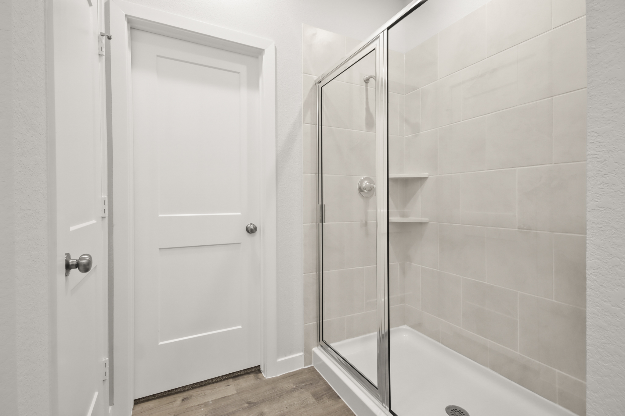 A shower with a glass door.