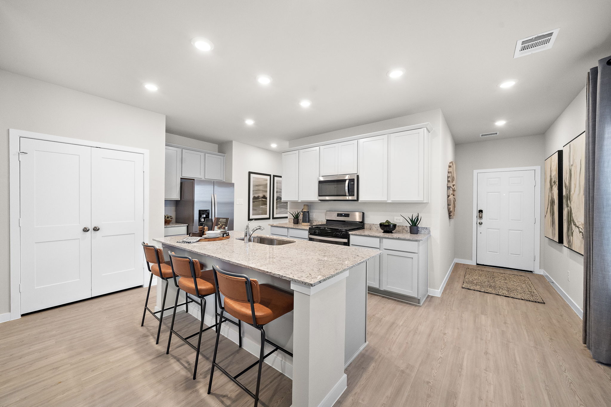 A kitchen with white cabinets.