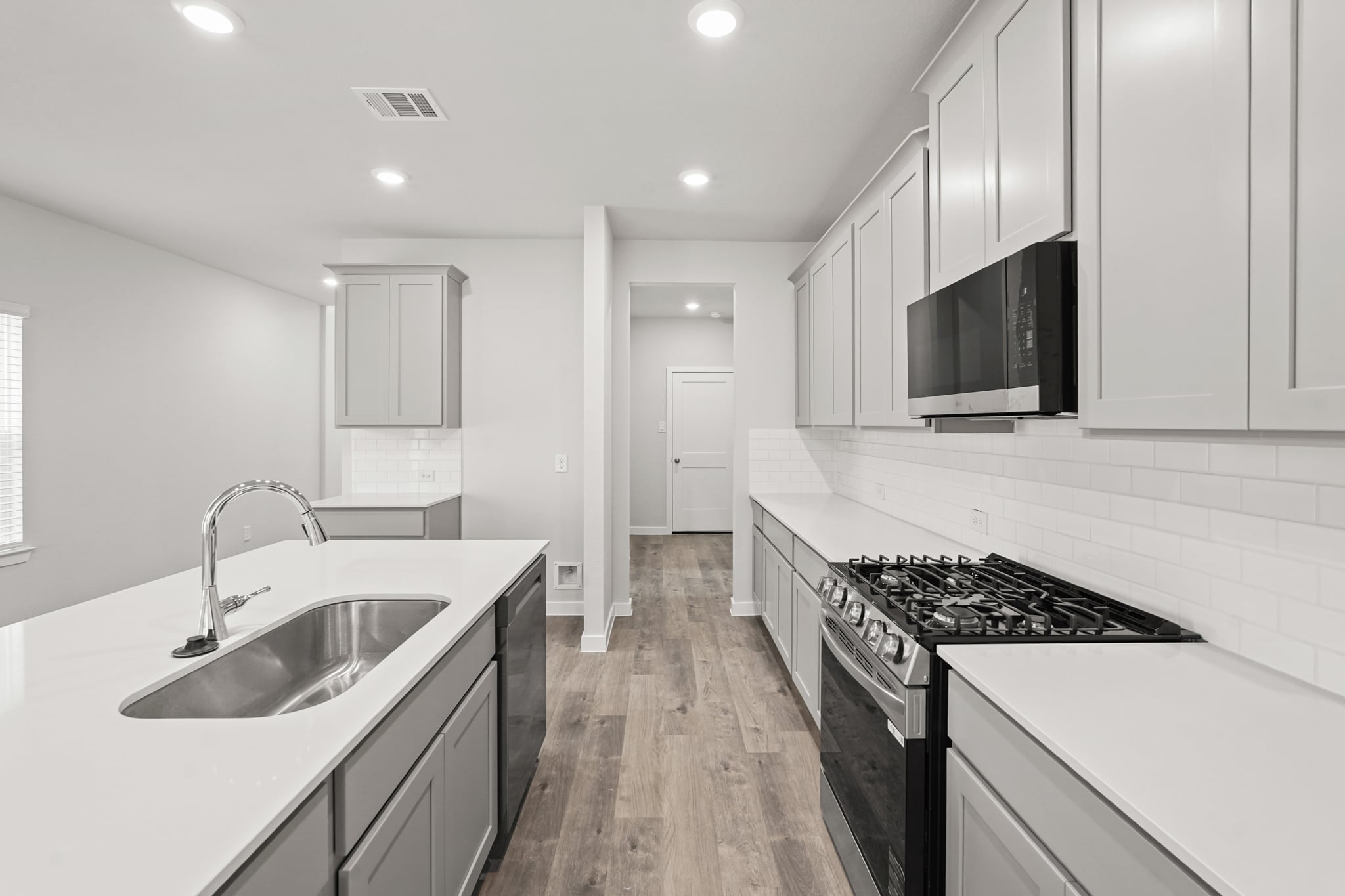 A kitchen with white cabinets.