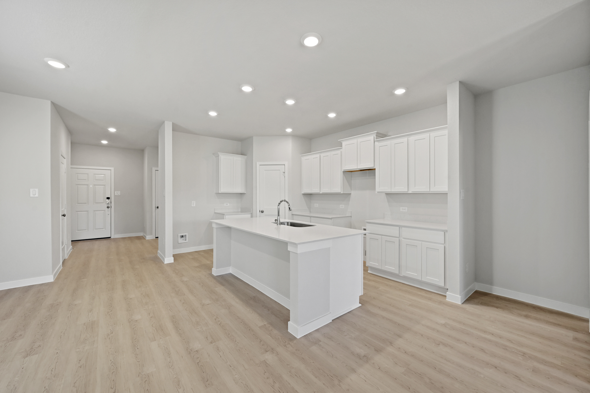 A kitchen with white cabinets.