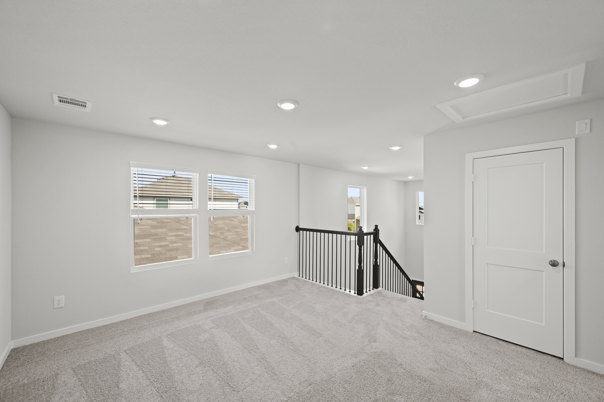 A room with a staircase and a door.