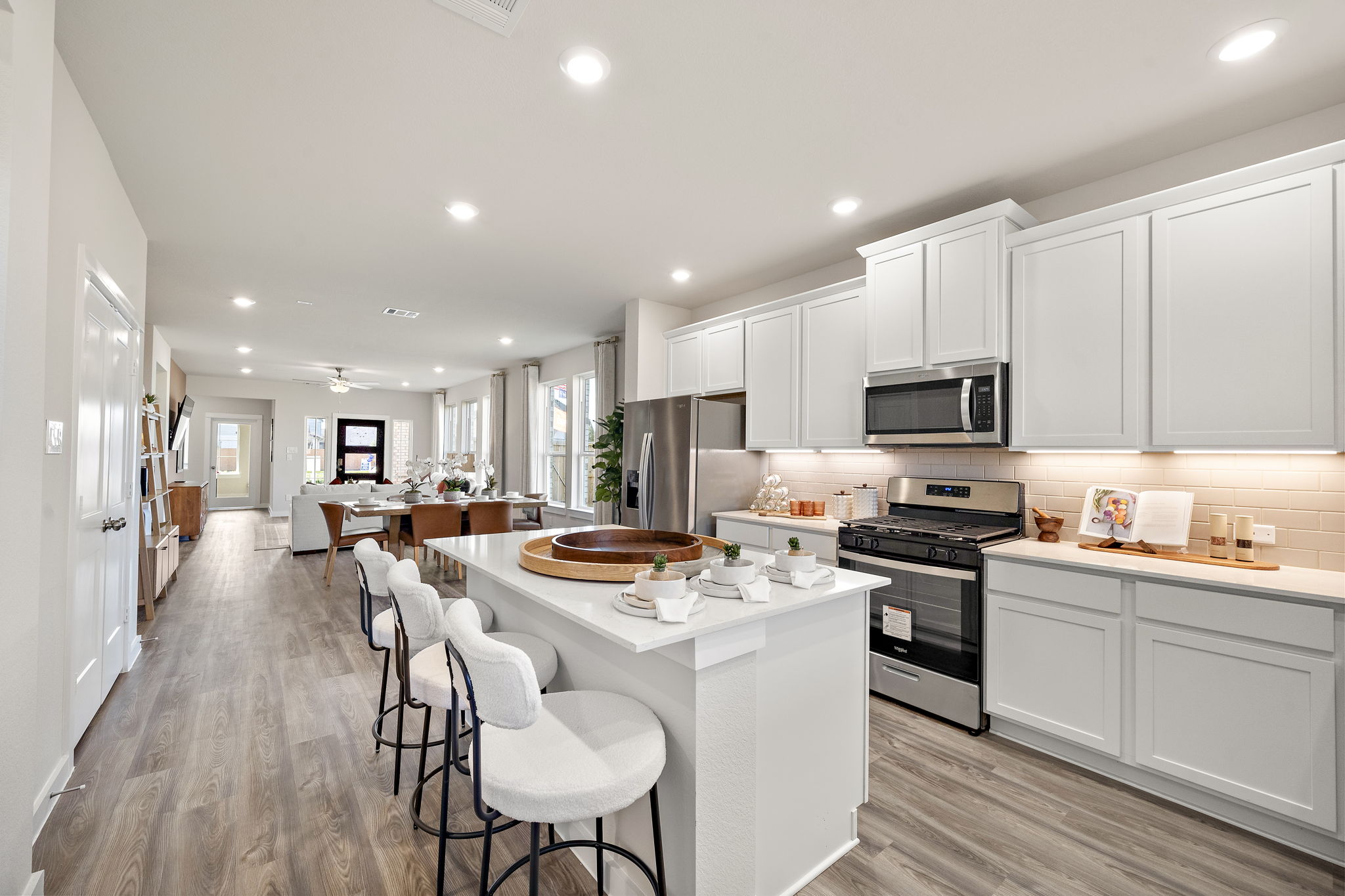A kitchen with white cabinets.