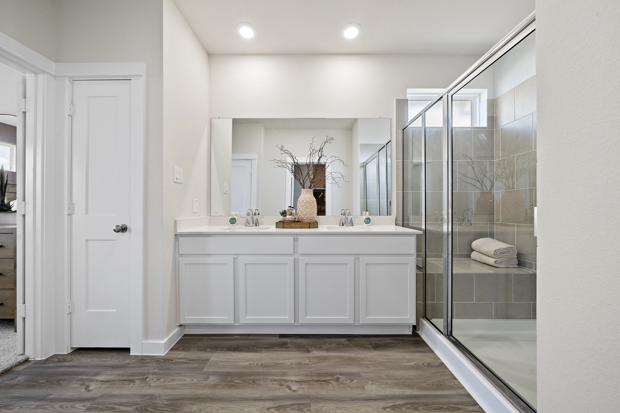 A bathroom with white cabinets.