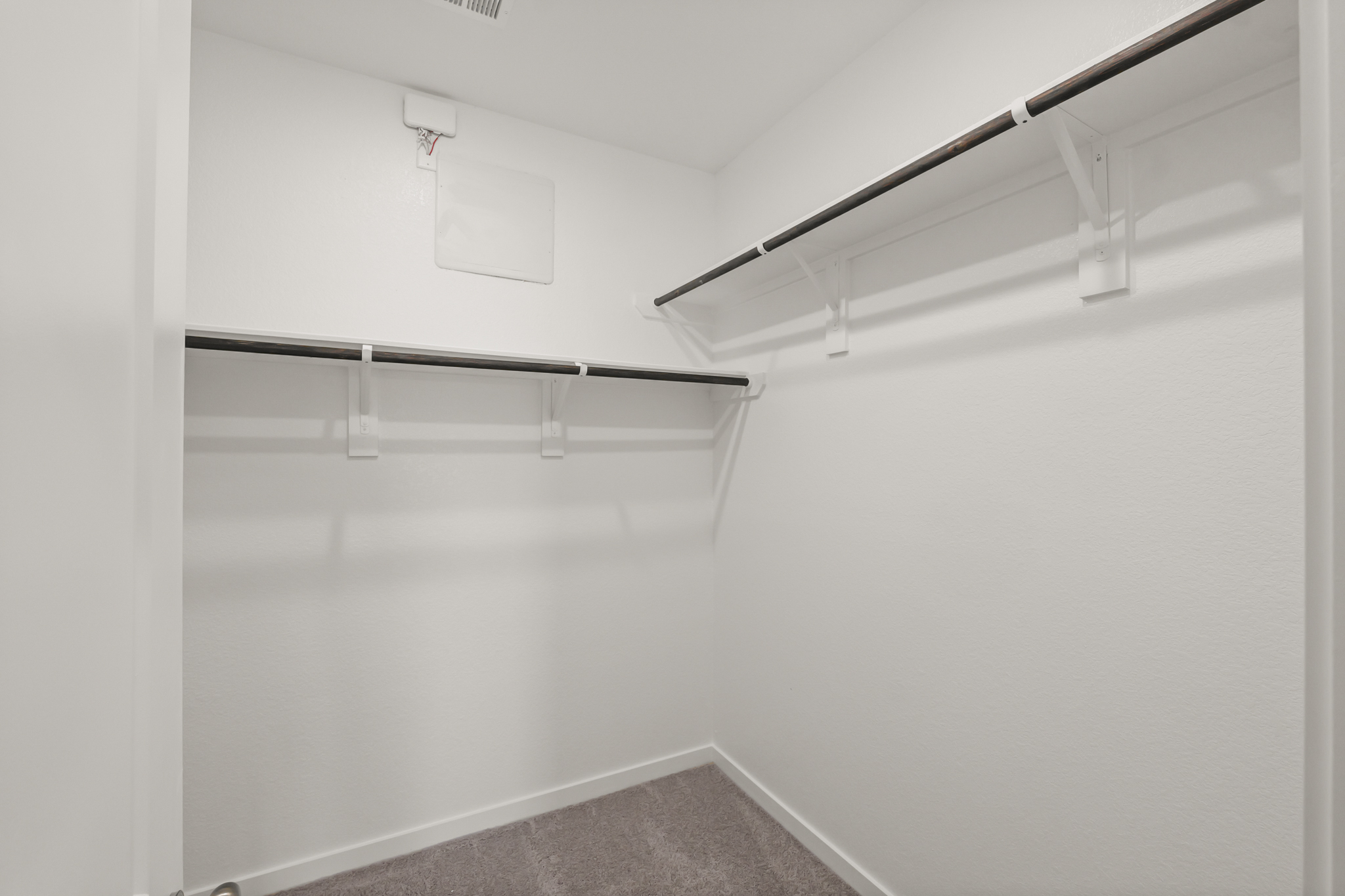 A white wall with a metal railing.