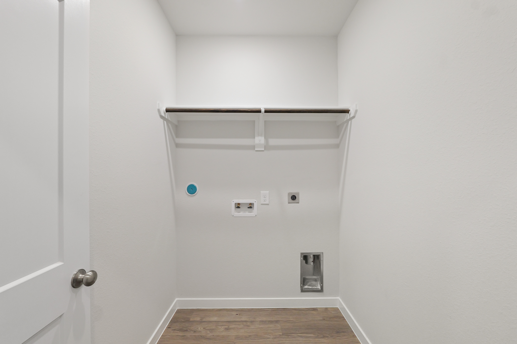 A white wall with a light fixture.