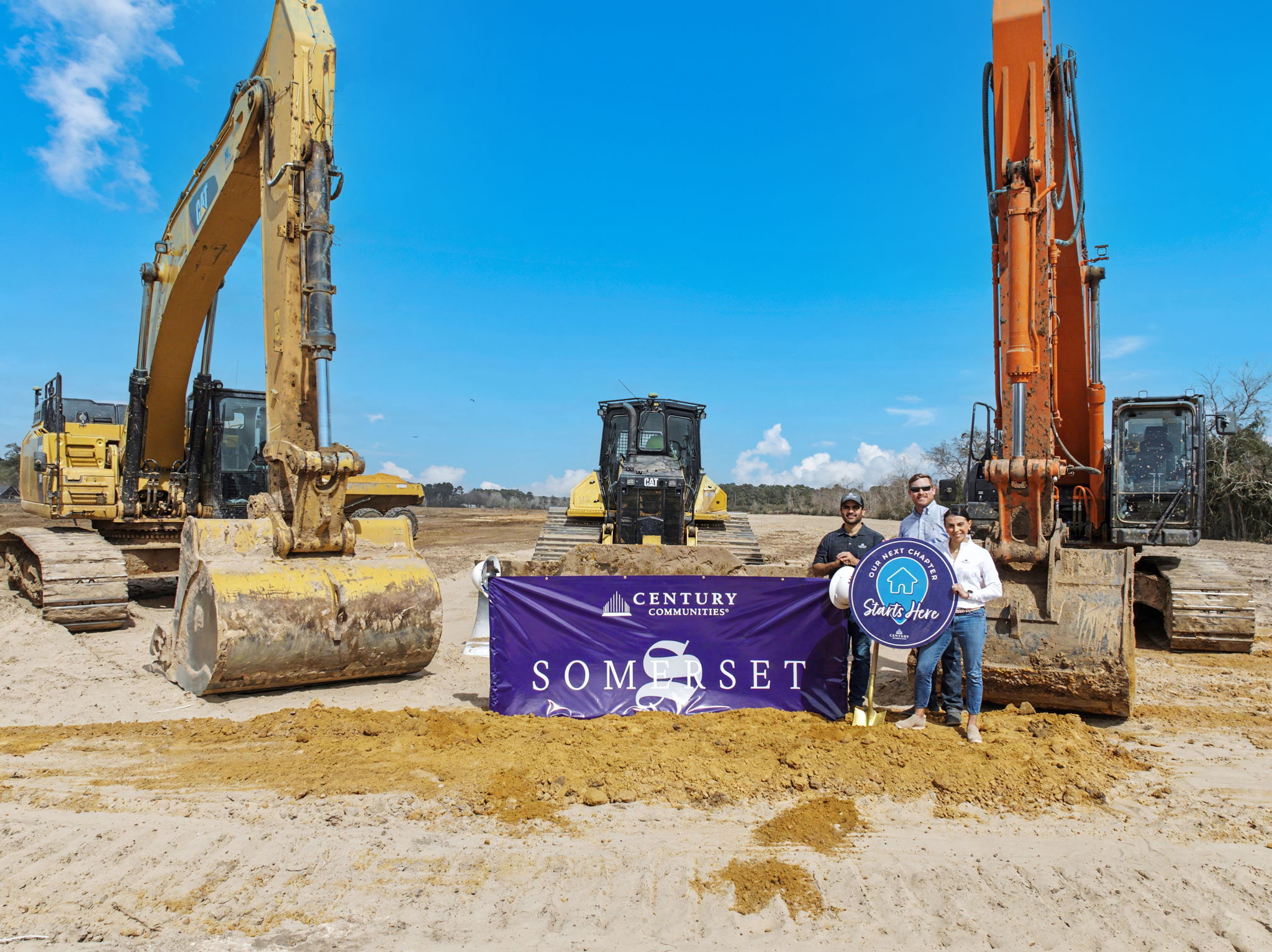 A few men standing next to a sign and a construction site.