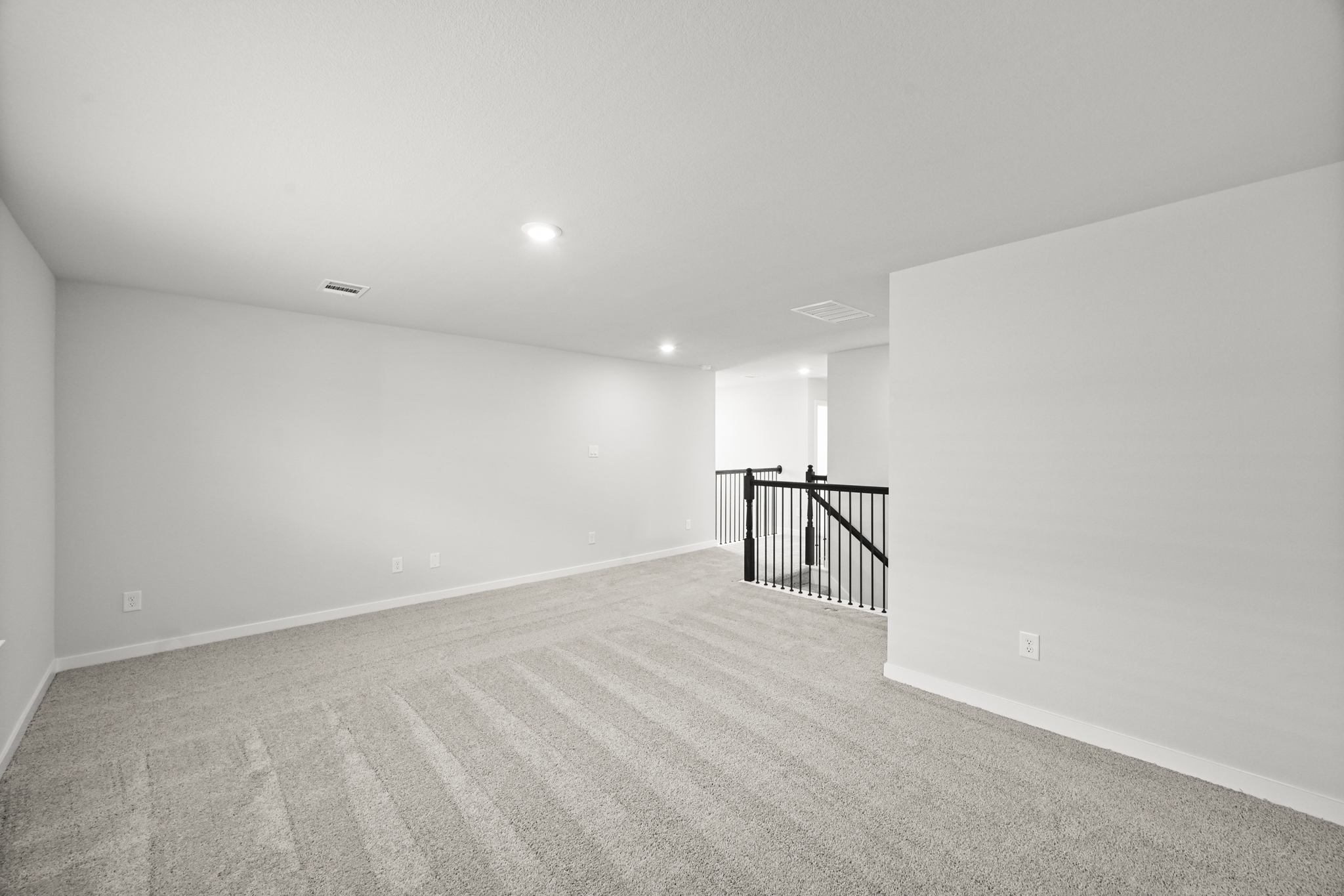 A hallway with a railing.