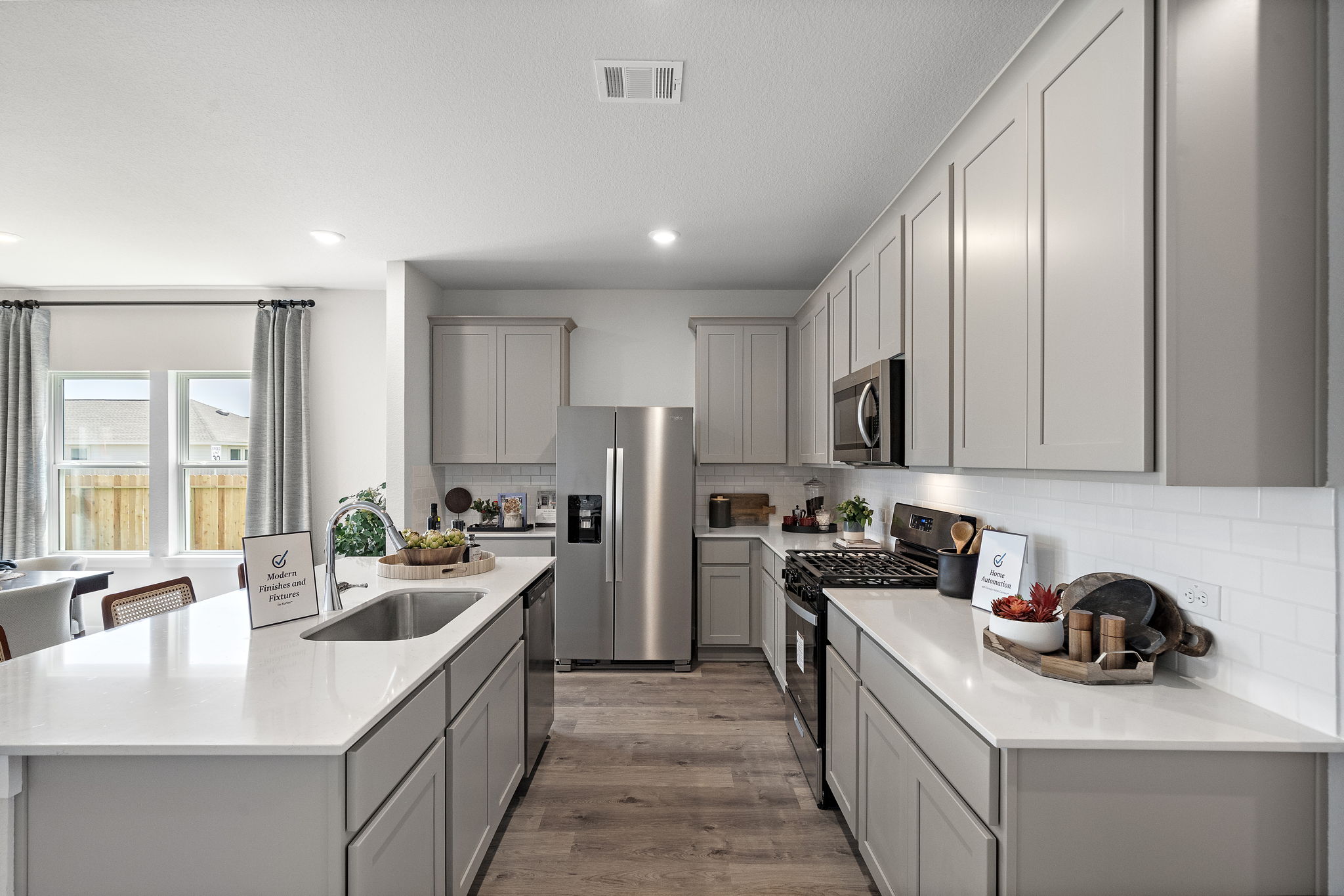 A kitchen with white cabinets.
