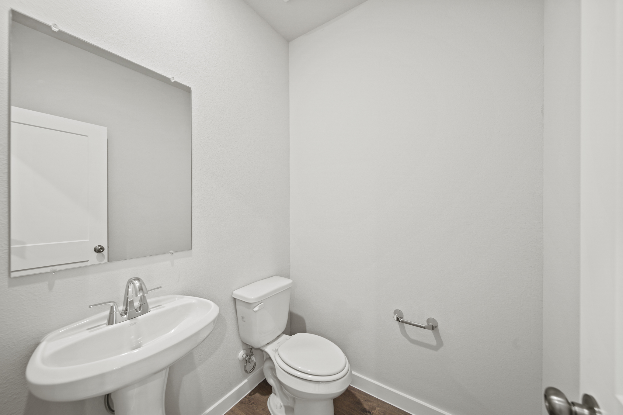 A bathroom with a toilet and sink.