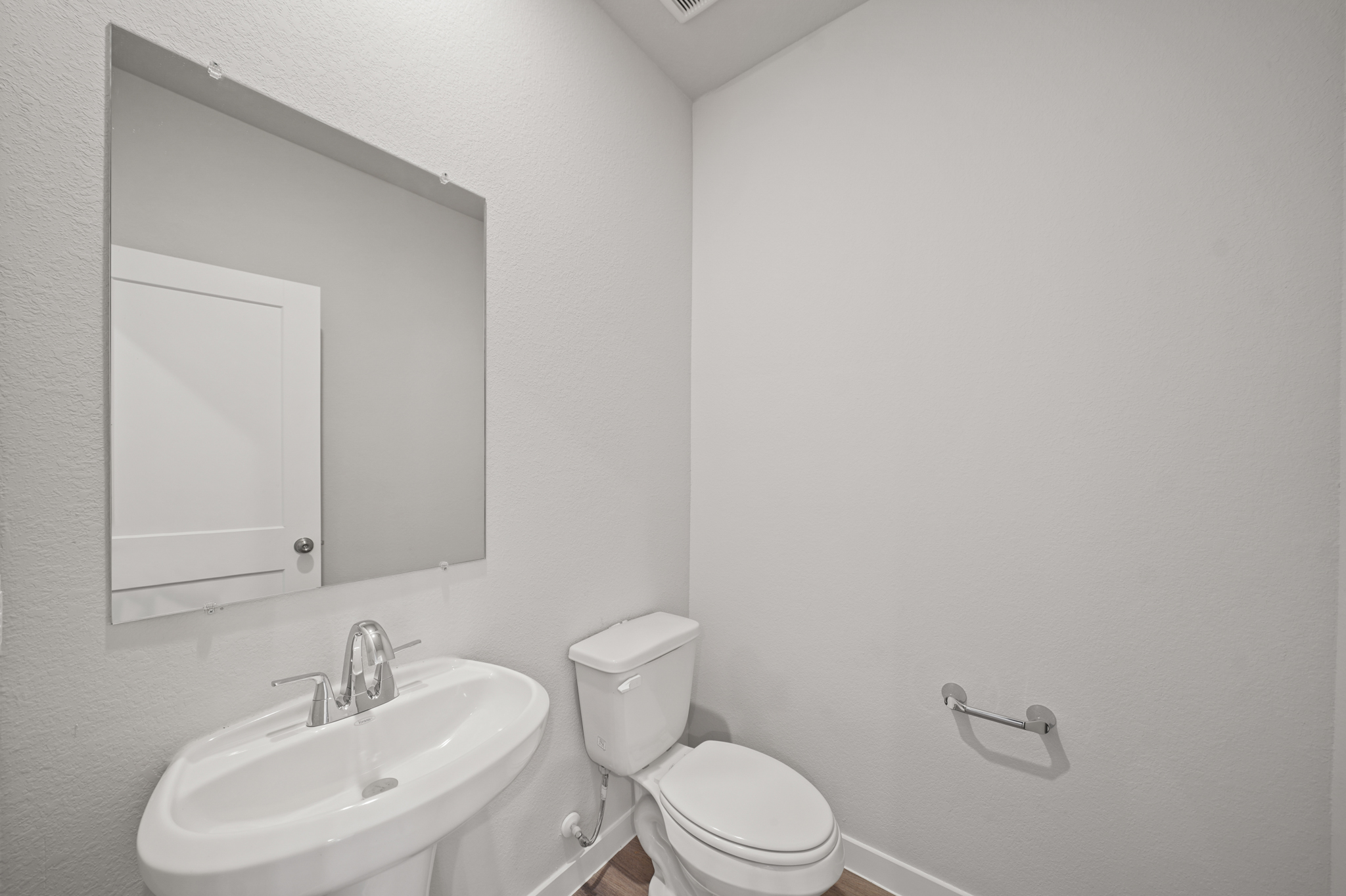 A bathroom with a toilet and sink.