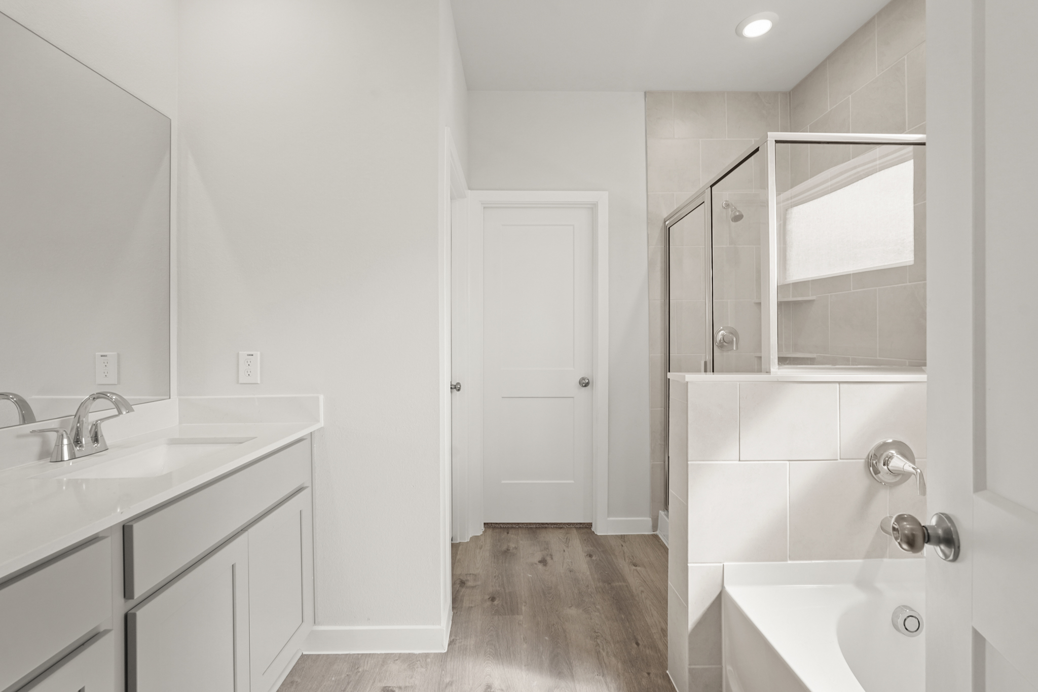 A bathroom with white cabinets.
