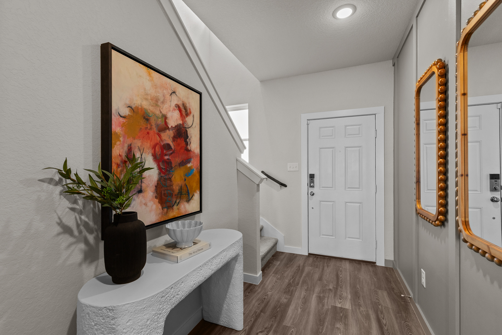 A room with a table and a mirror.