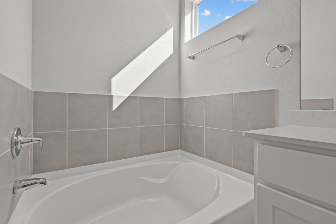 A bathroom with a tub and sink.